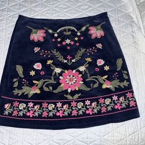 Blue ribbed skirt with pink embroidery